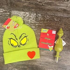 Grinch Green Beanie with Heart Patch, bracelets, and pen.